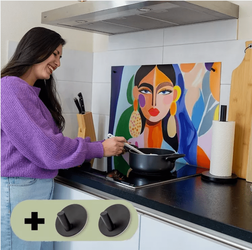 Vrouw met paars shirt staat in de keuken en gebruikt een ophangsysteem voor een inductiebeschermer.